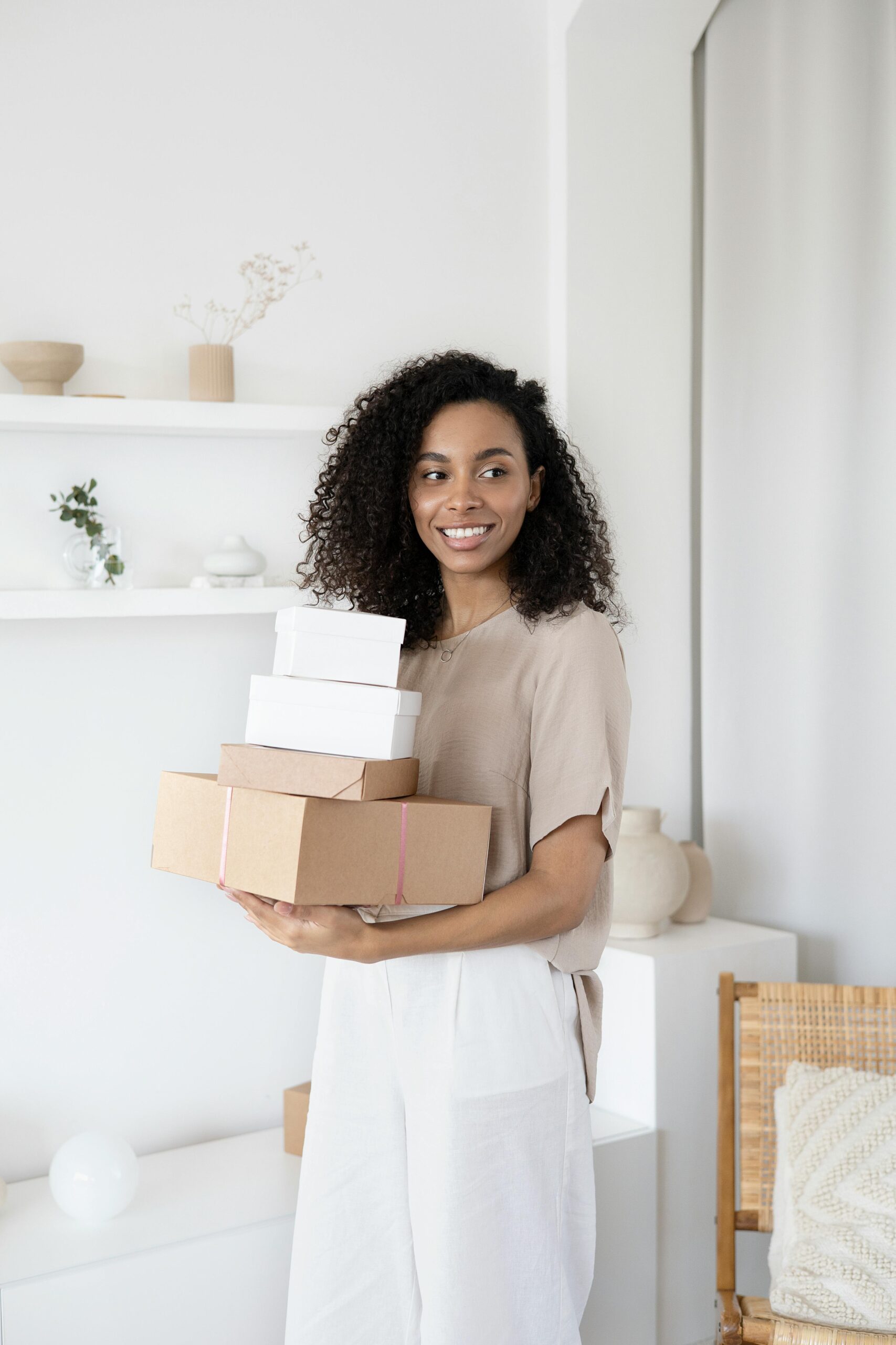 woman with curly black hair holding packages