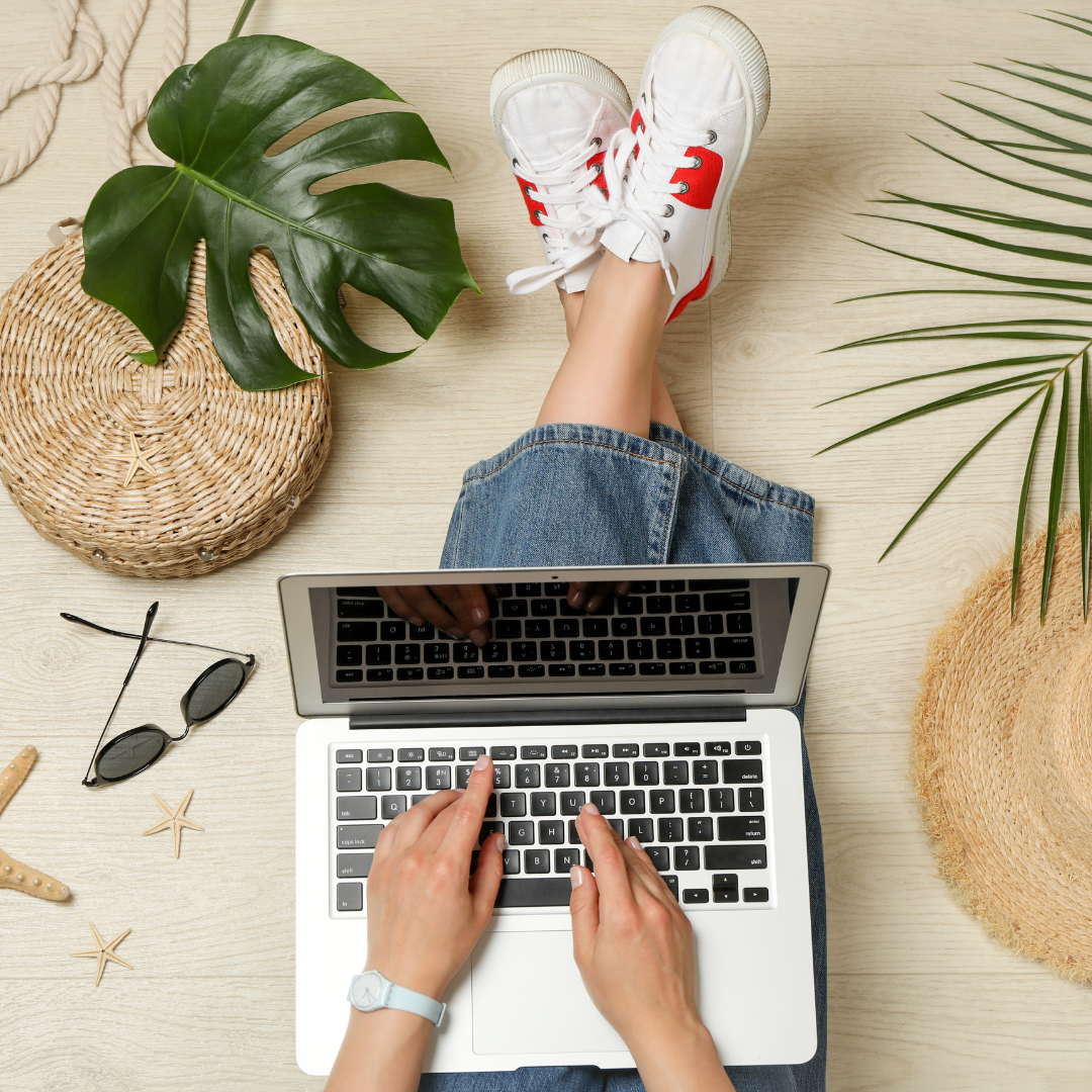 Image is a picture of a laptop with a women's hands over the keyboard and you can see her legs and sneakers and a pair of sunglasses to the side. This is an image for ep 121 on the top tech tools for small businesses