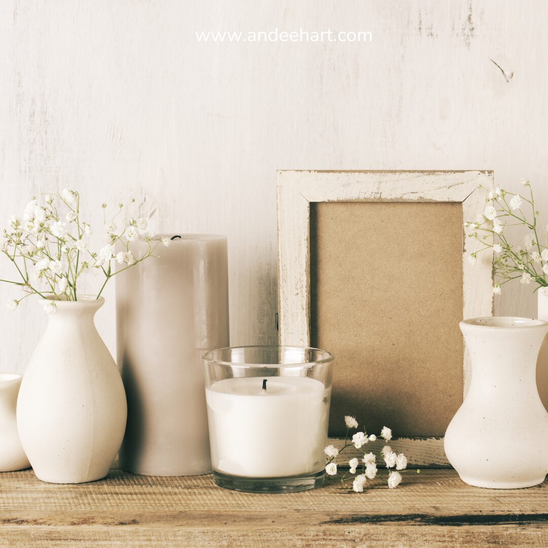 Image has candles, vases and picture frame in it. They are cream colored with a cream color background