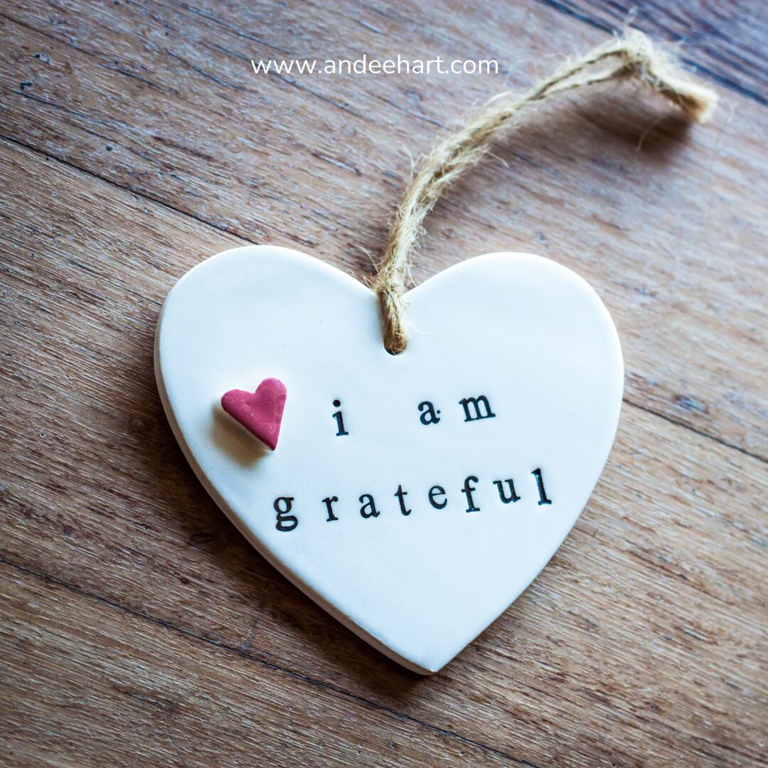 Image is a head pendant that says I am grateful