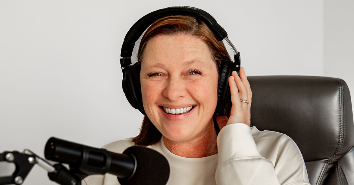 Image is of Liz Chapman, podcast manager, and guest on the She Sells Differently podcast, she is smiling at the camera with headphones on and a microphone near her mouth