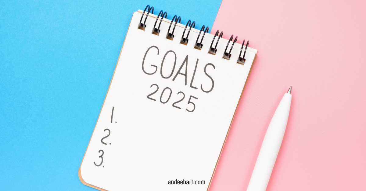 Image is picture with a pink and blue background and has a notebook that says Goals for 2025 and a pen