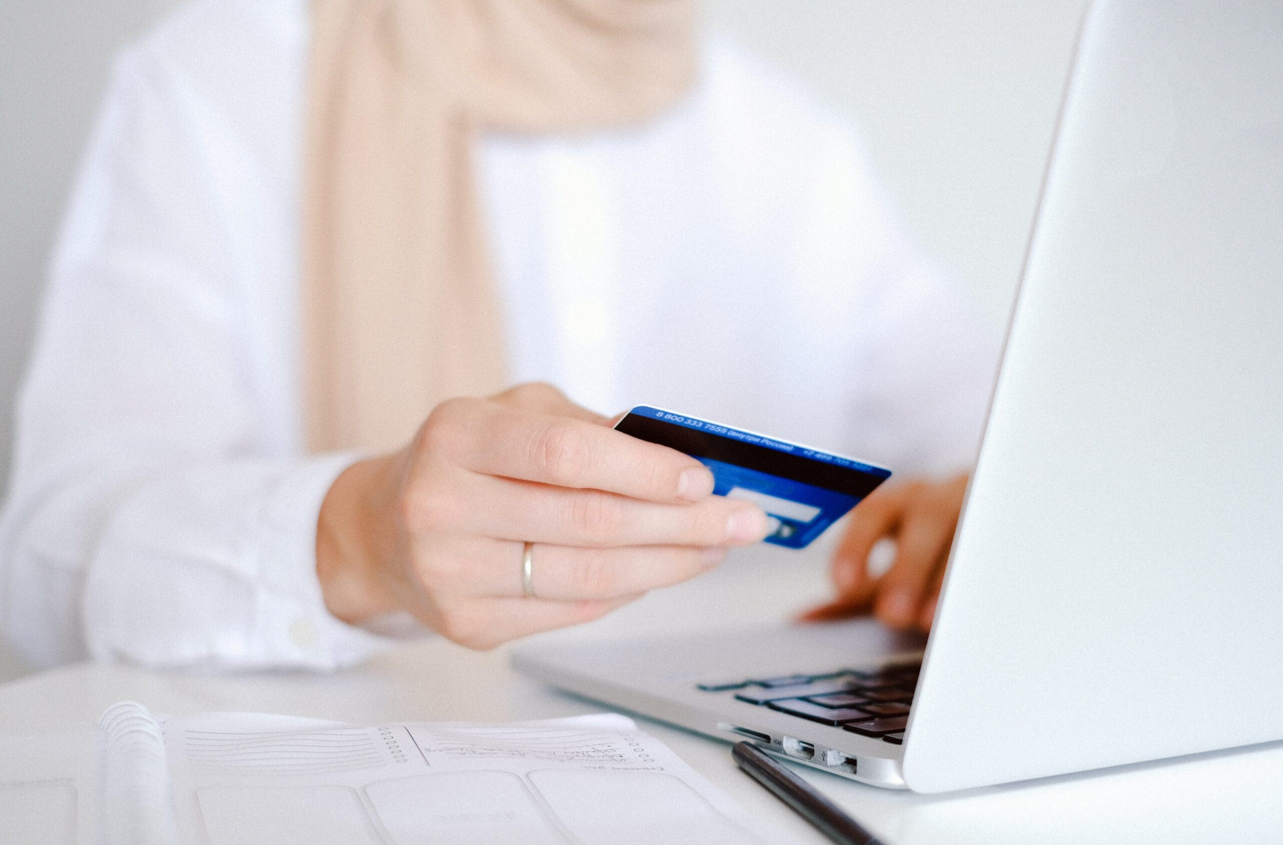 Woman using a credit card on a laptop